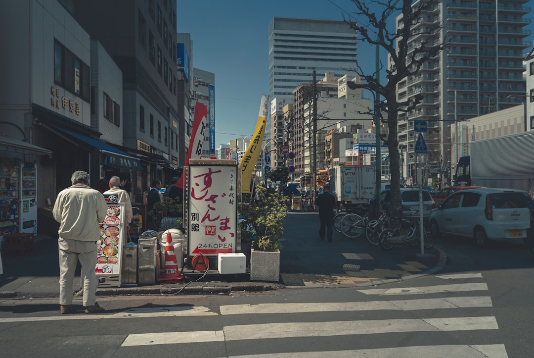 people walking on sidewalk near buildings during daytime