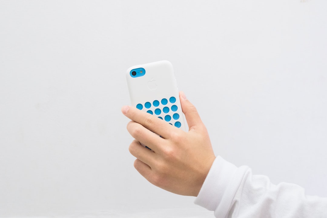 a person holding a small blue device